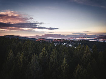 Scenic view of landscape against sky at sunset