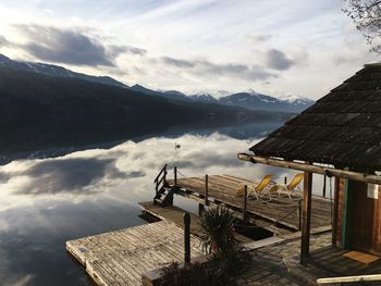 Houses by mountains against sky