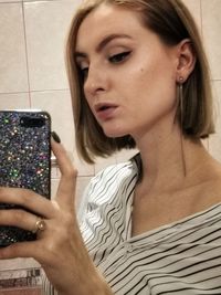 Portrait of young woman using mobile phone