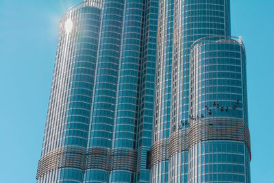 Low angle view of modern building against blue sky