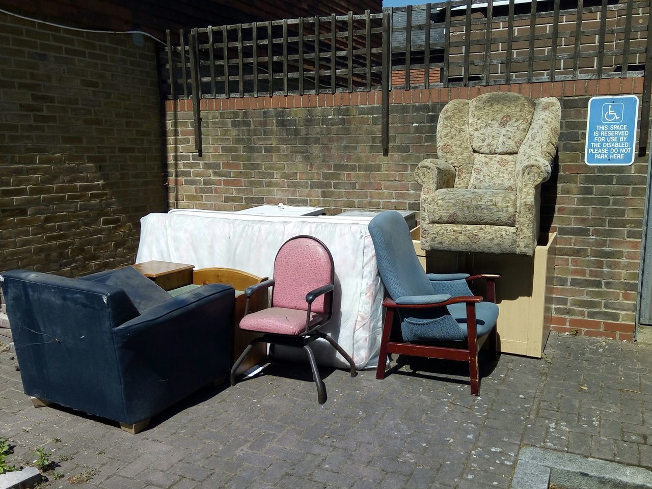 CHAIRS IN FRONT OF AN ABANDONED BUILDING