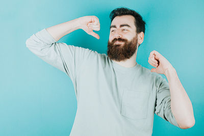 Portrait of young man against blue background