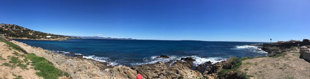 Scenic view of sea against clear blue sky