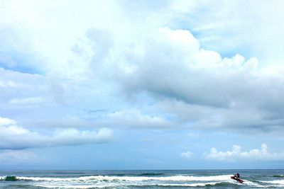 Scenic view of sea against cloudy sky