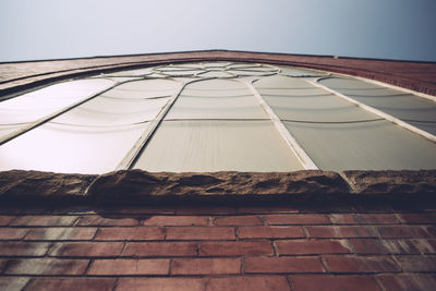 Low angle view of building window against clear sky