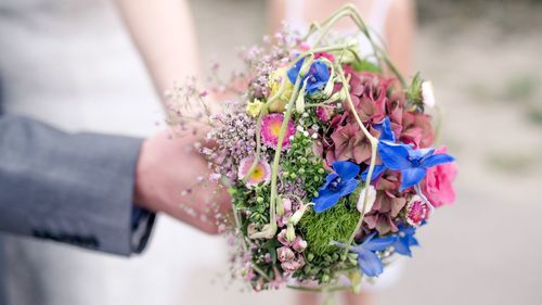 Close-up of hand holding bouquet