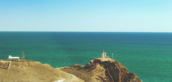 Scenic view of sea against clear blue sky