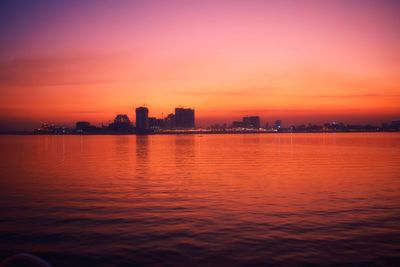 City at waterfront during sunset