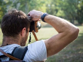 Portrait of man photographing outdoors