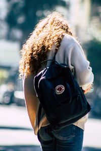 Rear view of woman standing outdoors