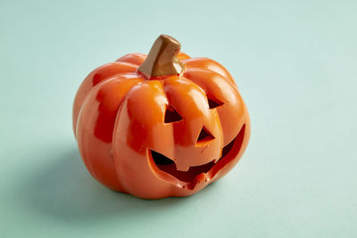 Close-up of pumpkin against orange background