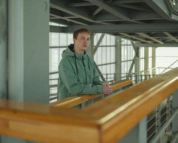 Portrait of boy standing in corridor