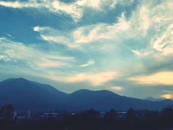 Scenic view of silhouette mountains against sky at sunset