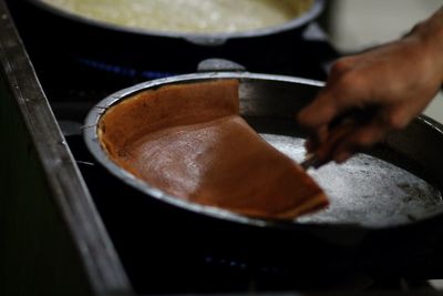 Close-up of person preparing food at restaurant