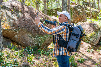 Rear view of man standing on rock