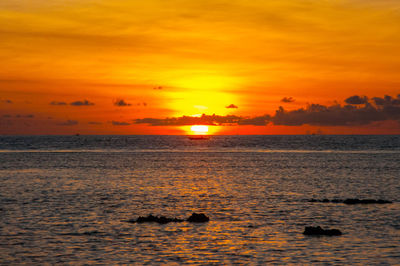 Scenic view of sea against orange sky