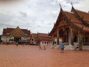 Group of people in front of building against sky