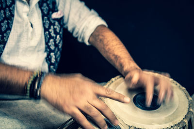 Close-up of man holding hands on table