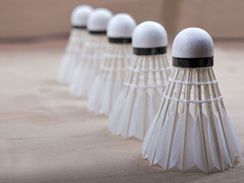 Close-up of shuttlecocks arranged on table