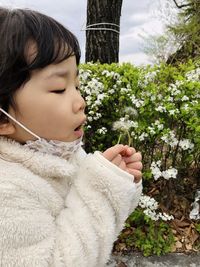 Side view of woman looking at snow