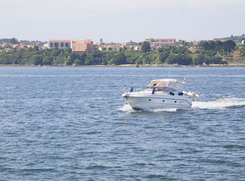 Boat sailing in sea against sky