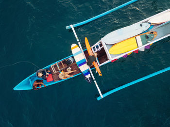 Aerial view of surfers and boat in the ocean, lombok, indonesia
