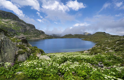 Scenic view of sea and mountains against sky