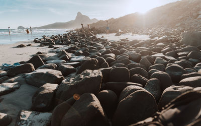 Rocks on beach against sky