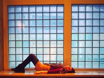 Woman sleeping on window