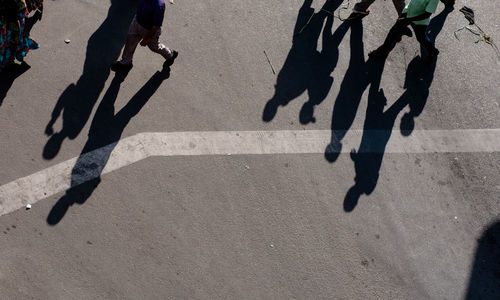 Low section of people walking on road