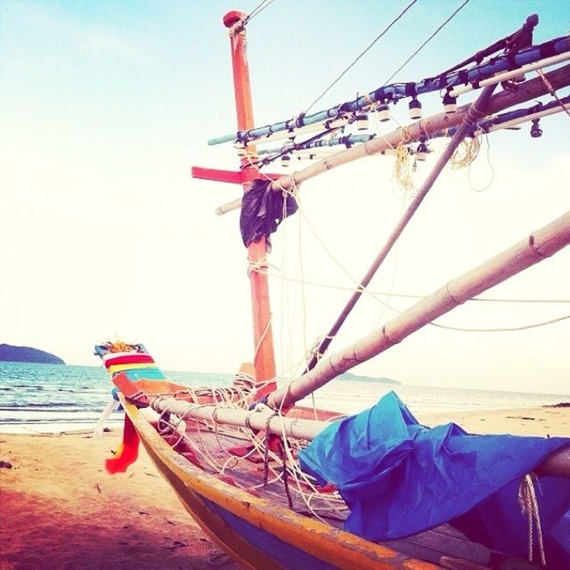 nautical vessel, transportation, mode of transport, boat, sea, moored, water, beach, rope, sky, sailboat, clear sky, shore, mast, travel, sand, part of, day, outdoors, harbor