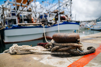 Close-up of fishing boat moored at harbor