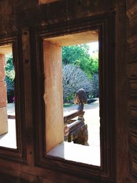 Man seen through window