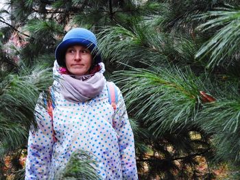 Portrait of cute girl standing against plants