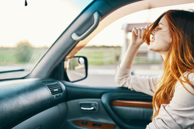 Portrait of woman sitting in car