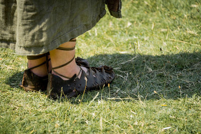 Low section of woman on field