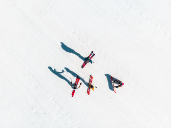 High angle view of people skiing on snowy field