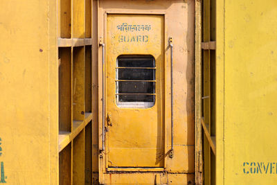 Text on yellow door of building