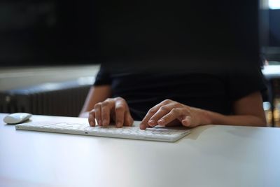 Midsection of person working on table