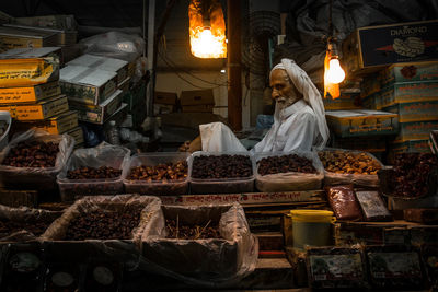 Woman for sale at market stall