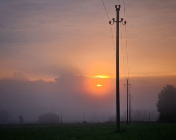 Scenic view of silhouette field against sky during sunset