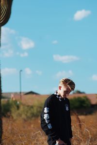 Man standing on field against sky