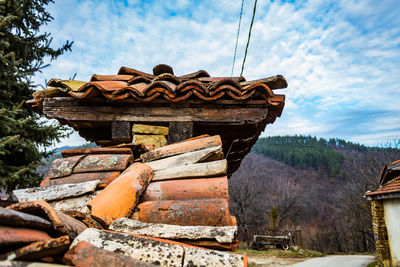 Wooden structure on land against sky