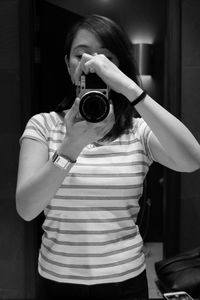 Young woman photographing through camera