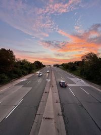 Car on road against sky during sunset