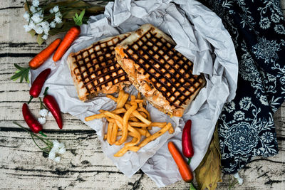 Close-up of wrap sandwich with french fries on table