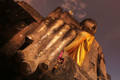 Low angle view of statue against historic building