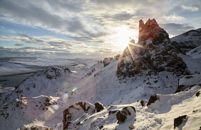 Scenic view of snow covered mountains against sky