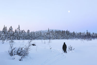 Snow covered field against sky