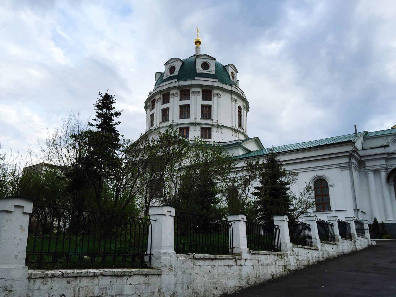 building exterior, architecture, built structure, sky, cloud - sky, religion, church, place of worship, spirituality, cloud, tree, low angle view, house, day, cross, cloudy, facade, outdoors